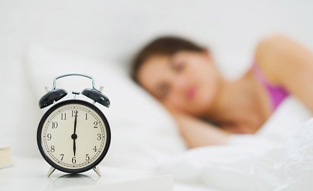 alarm clock bed table woman