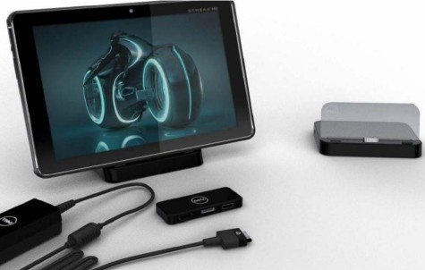 Ein Tablet mit futuristischem Design, darunter ein Standfuß, sowie angeschlossene Kabel und ein kleiner Docking-Adapter.